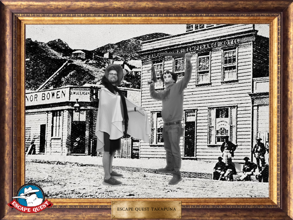 Two costumed idiots in an old-timey black and white photo against a frontier town, in our victory pose.
